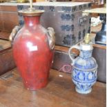 A large red and gilt table lamp and a stoneware jug converted to a table lamp (2)