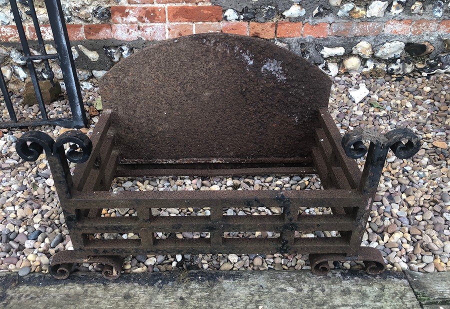 A Georgian style cast and wrought iron fire basket with arched fireback, weathered