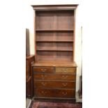 An oak dresser, the chest of two short over three long drawers with associated open bookcase top