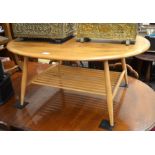 A 1960'S Ercol beech and elm oval coffee table with spindle under tier