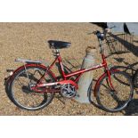 A vintage Triumph master shopper bike with front basket and rear pannier rack