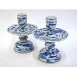 A pair of Chinese blue and white, candle or joss-stick holders; each one with circular plate