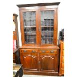 A mahogany chiffonier bookcase with leaded and stained glass doors over base with two drawers and