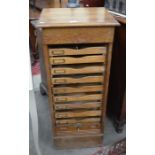 An early 20th century oak tambour front stationary cabinet with nine slides, Alfred Allen,