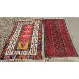 A Persian Baluch rug, the central reserve with a row of geometric guls on maroon ground to/w an