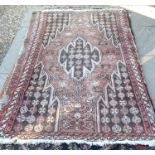 A Persian Hamadan rug, the dark central medallion on rust ground decorated with rosettes within