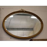 An Edwardian oval bevelled edge wall mirror in gilt rope-twist frame