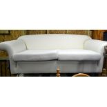 A calico covered two seater scroll arm sofa c/w cushions and loose covers