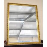 A large bevelled edge mirror in gilt foliate frame matching lots 427 and 428
