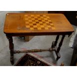 A Victorian mahogany inlaid chess top table raised on turned column supports united by stretchers