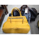 A black and brown leather effect holdall marked 'Ted Baker' and a mustard suede effect Accessorize