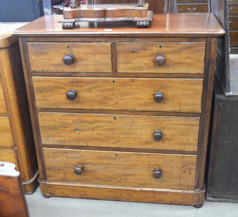 A Victorian mahogany chest of two short over three long drawers with turned pulls, one missing,