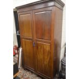 Edwardian mahogany wardrobe with a pair of full length panelled doors enclosing hanging rail, raised