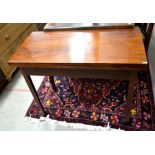 A 19th century mahogany tea table with folding rectangular top raised on chamfered square supports