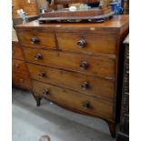 A 19th century  mahogany chest of two short over three long drawers with turned pulls, raised on