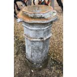A large weathered antique terracotta chimney pot, of tall octagonal form