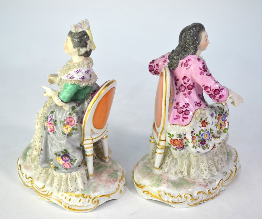 A pair of 19th century Berlin porcelain seated ladies with floral painted dresses and lacy - Image 2 of 4