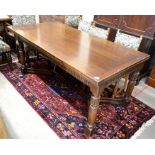 A rectangular oak draw leaf refectory table, the cleated planked top on a carved frieze and turned