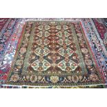 Persian Esfahan navy ground rug with two rows of ten floral medallions, within diamond guarded