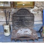 An antique cast iron fireback, with twin relief cast anchors, fleur-de-lys and roses and dated '