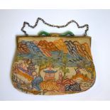 An early 20th century Chinoiserie tapestry handbag with green hardstone clasp, the bag depicting