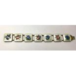 A Norwegian enamel bracelet, the seven white square guilloche enamel plaques decorated with flowers,