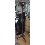 A late 19th/20th C mahogany tripod cloak stand, fitted with numerous brass hangers, the circular top