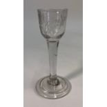 An 18th century cordial glass, ogee bowl engraved with a bird on one side, and a flower stem and