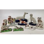 A collection of twelve 19th/20th century Staffordshire dogs including spaniels, dalmation and