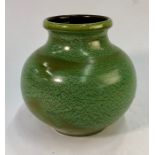 A Liberty, London red earthenware globular green glazed vase, Retailers stamp to base, 19 cm