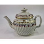 A late 18th century/early 19th century porcelain teapot and cover, spiral fluted oval body, leaf