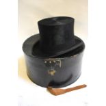 A vintage black silk top hat, retailed by Dunn & Co. hat makers, London, 55 cm circ. x 20 cm front