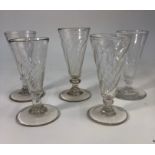 Five 18th/19th century short ale glasses with conical wrythen bowls, short knop stems and rough