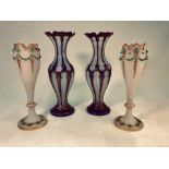 A pair of Bohemian blue overlay on opaque glass baluster vases with gilded vermicelli decoration,