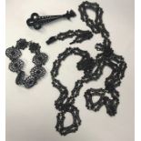 Three pieces of 19th century Berlin-work iron jewellery comprising a long chain formed of thirty-six