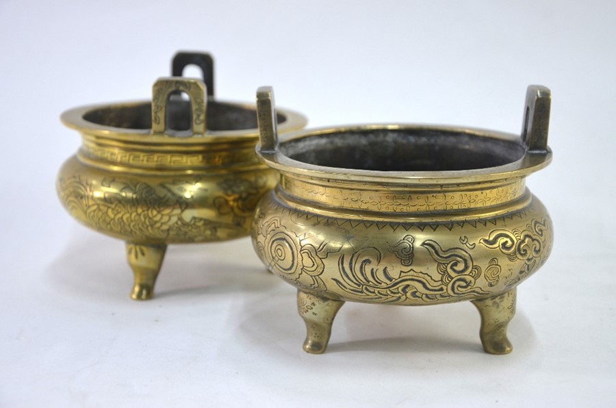 Two Chinese gilt incense burners; each one of typical tripod and circular form with pierced handles;