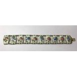 A Norwegian enamel bracelet formed of ten white rectangular guilloche enamel links decorated with