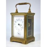 A brass cased French 8-day single train bell strike alarm carriage clock, with white enamelled