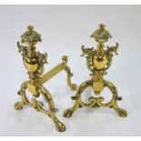A good quality brass pair of genets/fire dogs, cast with foliage and dolphins, 37 cm high