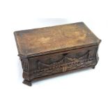 A 19th century Continental oak casket, the hinged top over a drawer, with applied swag moudings,