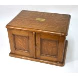 An oak four-drawer canteen enclosed by panelled doors (lacks contents and some fittings), 50 cm
