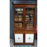 A late 19th century Arts & Crafts two tier cupboard, the four doors with hammered copper strap
