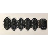 A Berlin-work iron cuff bracelet, circa 1850, comprising five finely cast and pierced plaques with