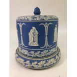 A large blue Jasper Ware stilton dish and cover decorated with classical figures and a frieze of