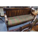 A vintage oak framed settle with drop-in overstuffed seat, probably a waiting room fitting, 182 cm