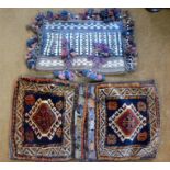 An Afghan double saddlebag set with keim backing, to/with another single bag with tassle and bead
