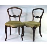 A set of six Victorian walnut framed balloon back dining chairs, the overstuffed serpentine form