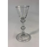 An 18th century style cordial glass, rounded funnel bowl, straight stem with shoulder and central