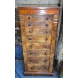 A Victorian walnut Wellington chest of eight graduated drawers with turned pulls, raised on a plinth