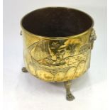 A 19th century circular brass log-bin decorated with sailing boats, lion mask ring handles, on